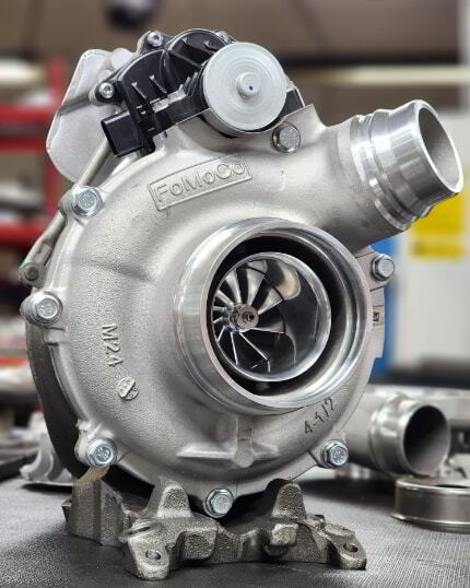 6.7 Powerstroke turbocharger on workbench during inspection or replacement